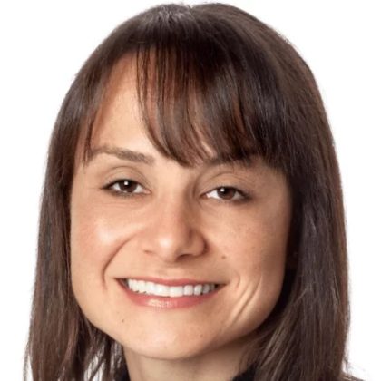 Dr Jacqueline Williams smiles at the camera. She has brown hair with bangs.