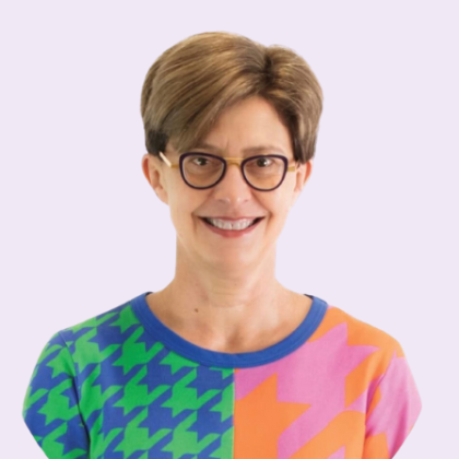 Dr Abbe Hollingworth smiles at the camera. She has short dark blonde hair and is wearing glasses